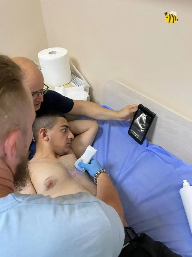 Échographie réalisée sur un patient allongé.